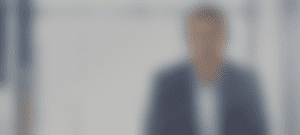 blurred image of a man in a suit