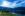 an image iof a lake with mountains in the background